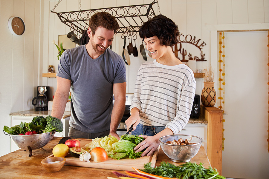 Man and Woman Chopping Vegetables While Preparing an Easy Dinner Idea