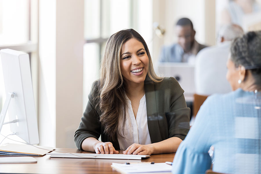 Smiling Woman Meeting with Financial Representative for a Cash Advance